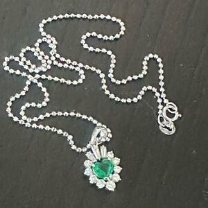 Columbian emerald heart with diamonds on a 18k white gold chain.